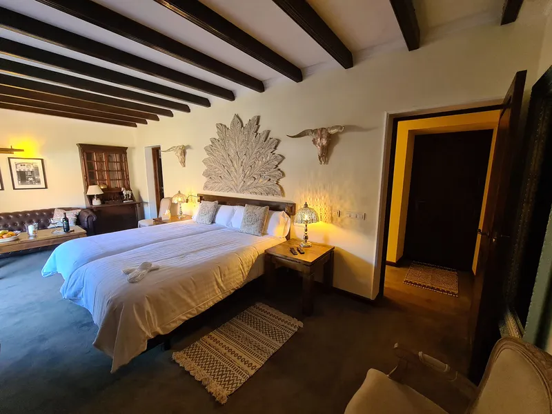 The bed beneath its carved, fan-shaped headboard