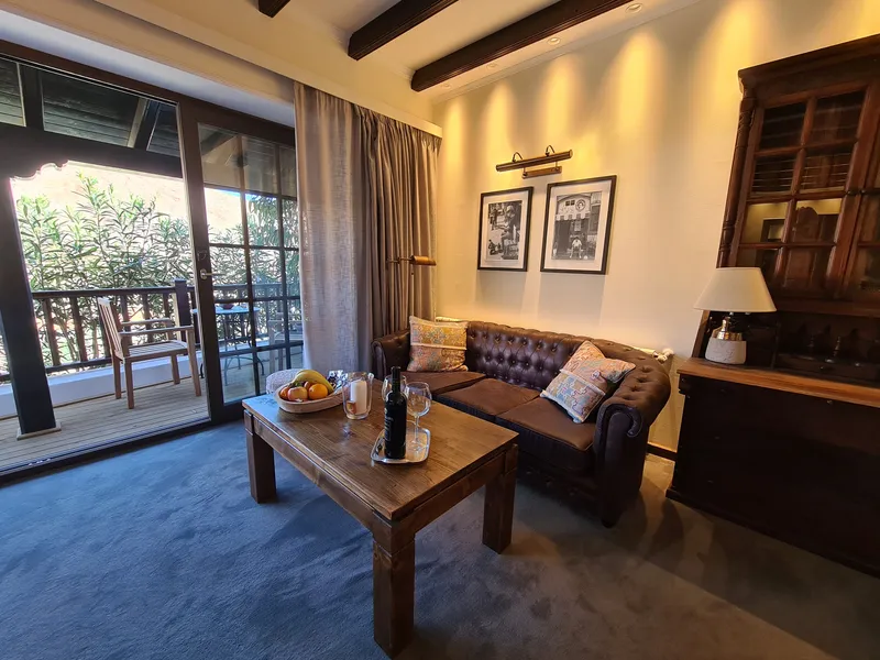 The sitting area with a leather sofa and a coffee table