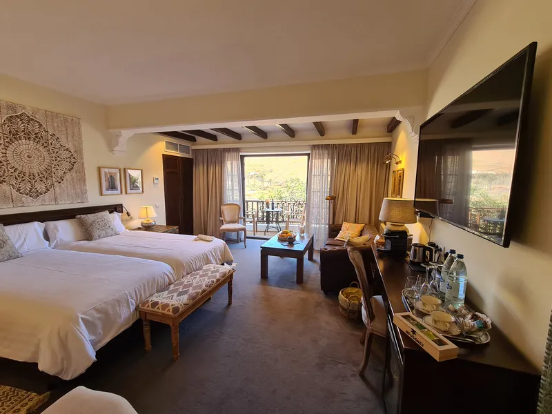 The beds, the sofa corner and the desk, with the terrace doors at the back