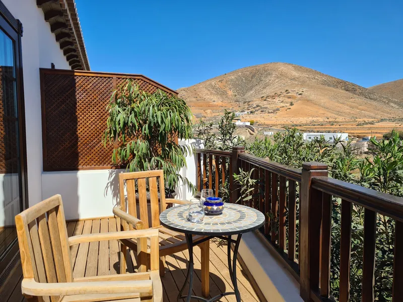 The terrace with a mosaic table, chairs and the mountain