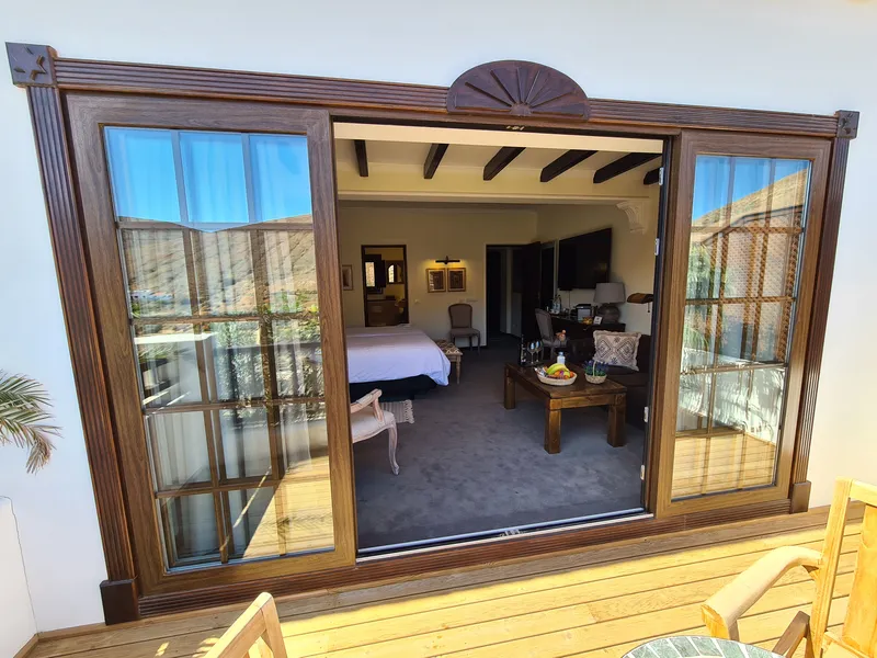 The room seen from the terrace through the open glass doors